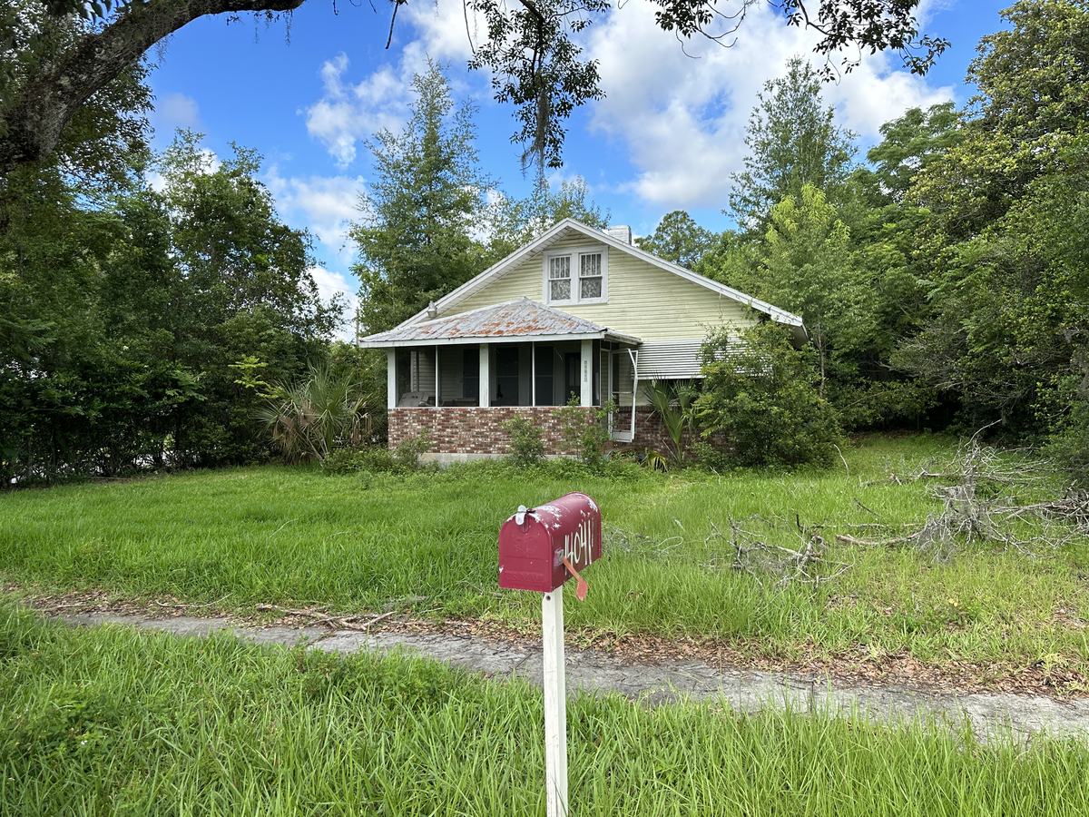 Overgrown, rusted porch roof