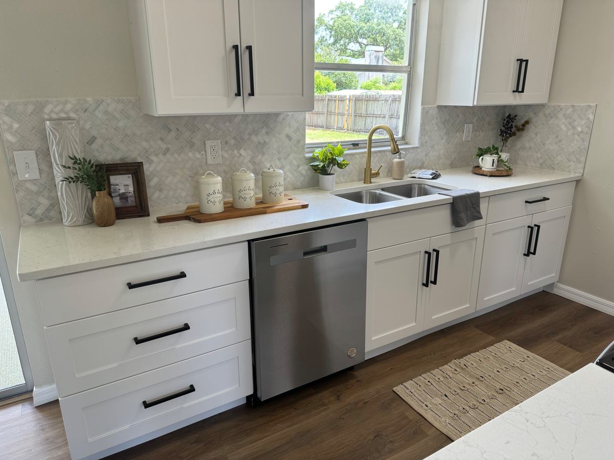 White cabinets, quartz, tile backsplash