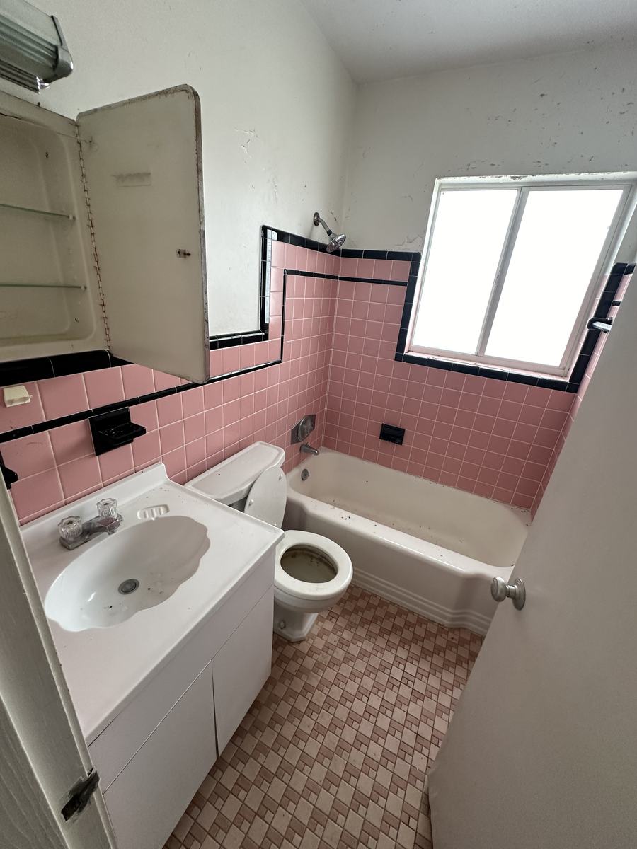 Original pink tile, worn fixtures
